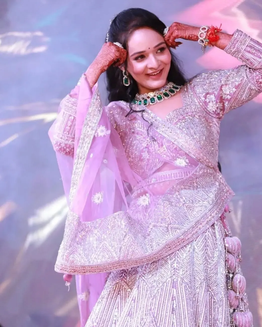 Bride in a lilac shimmer lehenga at her reception