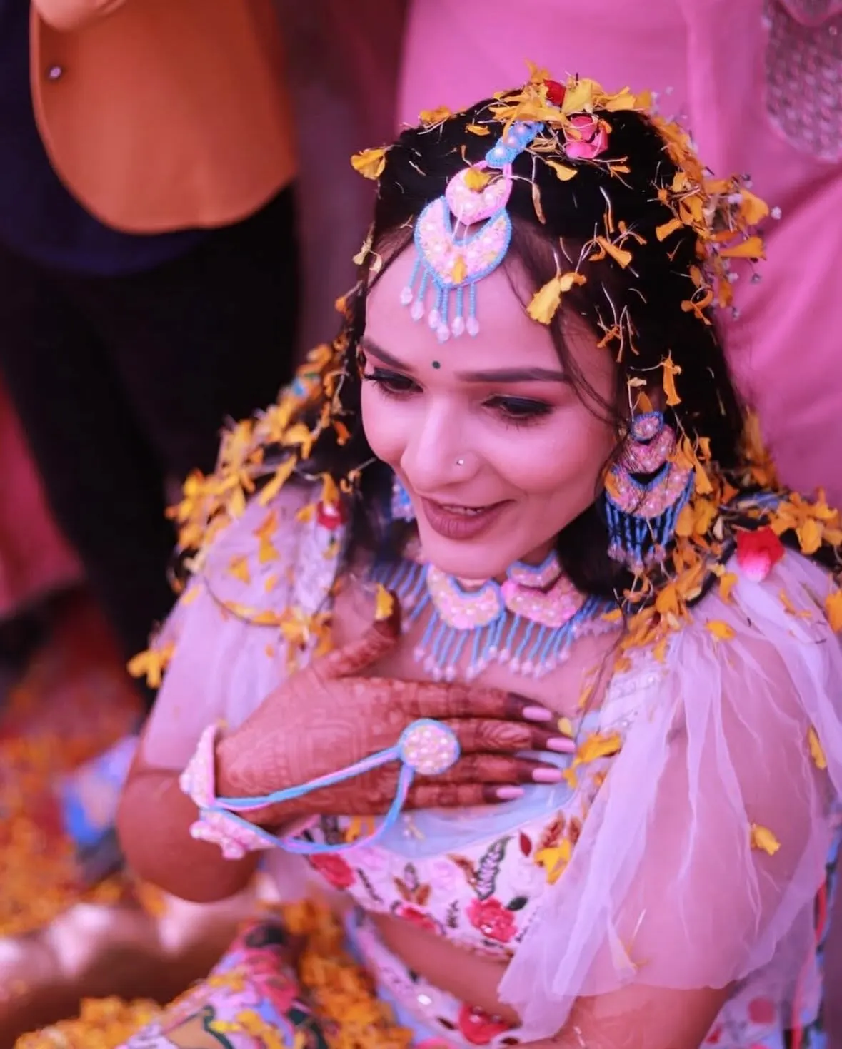 Bride showered in marigold petals at her haldi